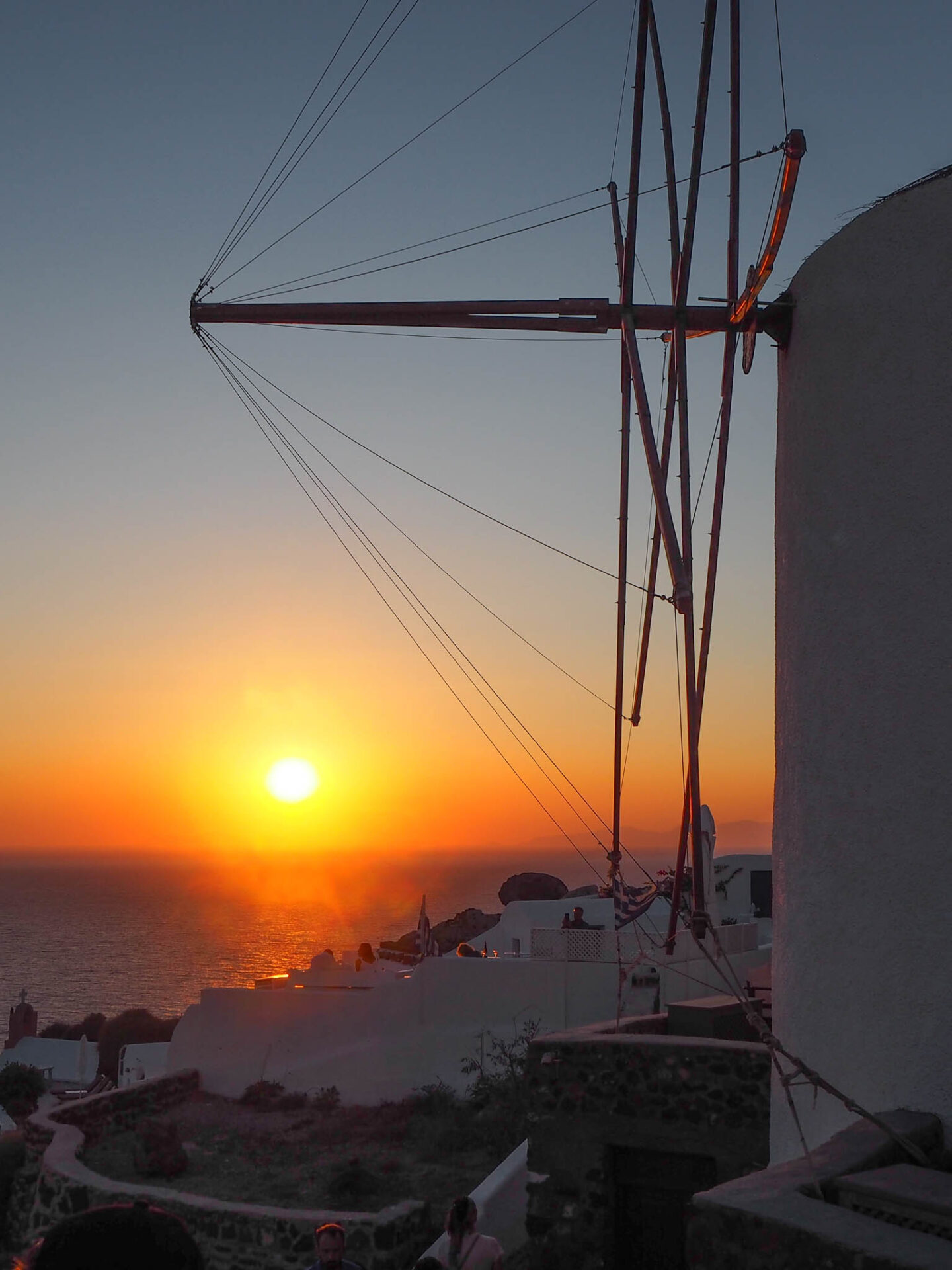 Santorini Oia golden sunset with windmill
